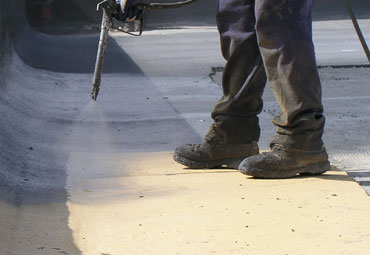 Coating systems over Norwalk spray foam roof systems